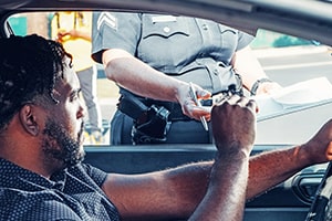 Police officer writing traffic ticket